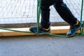 Foot of child doing balances on wooden boards in an urban adventure park