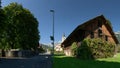 Swiss farmhouse and the Flums church of Saint Laurence