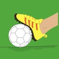 Foot in a football boot on a ball composition. Soccer player step on a ball laying on the stadium grass. Royalty Free Stock Photo