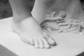 Foot. Fragment of an antique marble statue. Cracked ground in the background. Plaster limb, foot male with fingers, body Royalty Free Stock Photo