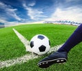 Foot kicking soccer ball Royalty Free Stock Photo