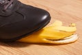Foot in leather brown shoe before slipping on banana peel Royalty Free Stock Photo