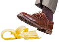 Foot in the left brown shoe slips on a banana peel Royalty Free Stock Photo