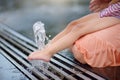 Foot of little disabled girl in the arms of his mother having fun in fountain of public park at sunny summer day. Child cerebral Royalty Free Stock Photo