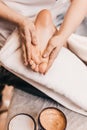 Foot massage normalizes blood pressure - a woman massages patient legs