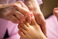 Foot massage in spa salon, closeup,Young woman having feet massage in beauty salon,female hands doing foot massage,Massage of hum Royalty Free Stock Photo