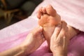 Foot massage in spa salon, closeup,Young woman having feet massage in beauty salon,female hands doing foot massage,Massage of hum Royalty Free Stock Photo