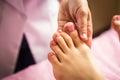 Foot massage in spa salon, closeup,Young woman having feet massage in beauty salon,female hands doing foot massage,Massage of hum Royalty Free Stock Photo