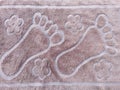 The foot mat's surface is constructed of cotton to absorb moisture. walking style. Royalty Free Stock Photo