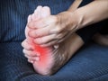 Foot pain, sore feet of young asian woman and use hand to massage feet and soles to relieve pain