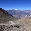 Foot path leading from Thorong La mountain pass towards Muktinath Royalty Free Stock Photo