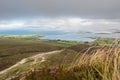 Foot path in a mountains with people walking up. Low cloudy sky. Croagh Patrick, Westport, county Mayo, Ireland, Travel and Royalty Free Stock Photo