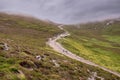 Foot path in a mountains with people walking up. Low cloudy sky. Croagh Patrick, Westport, county Mayo, Ireland, Travel and Royalty Free Stock Photo
