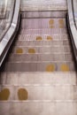 Foot point print sign on escalator in yellow to maintain distance during the Covid-19 pandemic, health care, Royalty Free Stock Photo