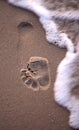 A foot print going to be covered by water Royalty Free Stock Photo