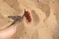 Foot in sand. child human bare feet buried in seaside photography. Kid toe hidden in sand. Girl playing on the shore beach and