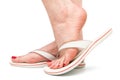 Foot in sandal on white background