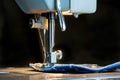 Foot of sewing machine on jeans fabric Royalty Free Stock Photo