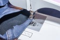 Foot of Sewing Machine on Jeans Fabric Royalty Free Stock Photo