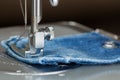 Foot of sewing machine on jeans fabric Royalty Free Stock Photo