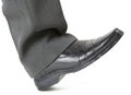 Foot in a shoe ready to crush Royalty Free Stock Photo