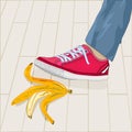 Foot in shoe step on banana peel. Leg stepping on dangerous slippery yellow fruit skin lying on sidewalk. Royalty Free Stock Photo