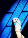 Foot slipper stepping on blue mat sad face shadow