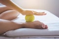 Foot soles massage,Woman hand giving massage with tennis ball to her foots in bedroom Royalty Free Stock Photo