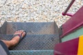 Foot on steel stair up and down of train