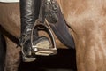 The foot in the stirrup of the rider in the correct position in the dressage saddle