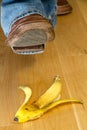 Foot about to tread on a banana skin Royalty Free Stock Photo