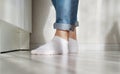 Foot, toes, socks, white, floor, jeans Royalty Free Stock Photo