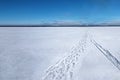 Foot track and sledge trace on frozen lake