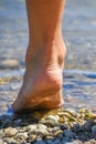 Foot Walking on Stony Beach Royalty Free Stock Photo