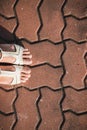 Foot woman shoe on the texture paving stone footpath background Royalty Free Stock Photo