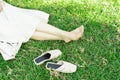 Foot of woman sitting on green grass at park ,rest and relax .Nature essential wellbeing and ability be productive