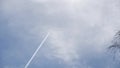 Footage of an airplane in the sky with contrails and clouds against a blue sky in summer in Bavaria, Germany