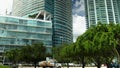 footage of a beautiful summer landscape at Maurice A. Ferre Park with black plastic sculptures, lush green trees and grass, high