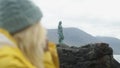 Footage of a blonde girl enjoying the view of of Kopakonan in Mikladalur, Faroe Islands