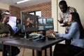 Footage editing specialist using multi monitor workstation to improve frames quality. Royalty Free Stock Photo
