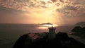 Lighthouse On Water's Edge At Sunset Footage 