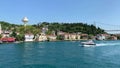 Footage of luxury yacht passing, historical, traditonal mansions in Beykoz / Kanlica area of Istanbul by Bosphorus strait.