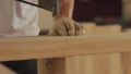 Footage of a specialist working on wood with nailgun