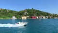Footage of speed boat passing, mansions and villas in Kanlica / Anadolu Hisari area of Istanbul by Bosphorus strait.