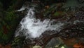 Water Flowing Down and Diverted by Large Boulder