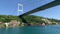 Footage of yacht passing, mansions and villas in Beykoz / Kanlica area of Istanbul by Bosphorus strait. FSM bridge is in the view