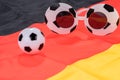 Football and abstract glasses on the german flag Royalty Free Stock Photo