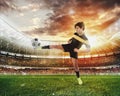 Football scene with competing young football players at the stadium Royalty Free Stock Photo