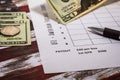 Football American office pool grid for sports betting concept with boxes, dollars, pen - blank grid Royalty Free Stock Photo