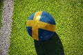 football ball with the flag of sweden on the green field near the white line Royalty Free Stock Photo